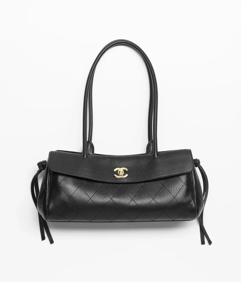 A black quilted Chanel small shopping bag.