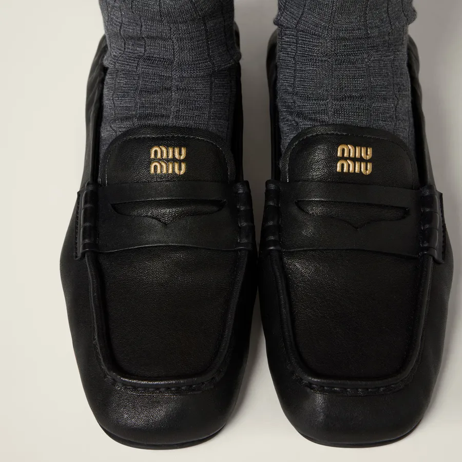 A pair of black Miu Miu nappa leather loafers.