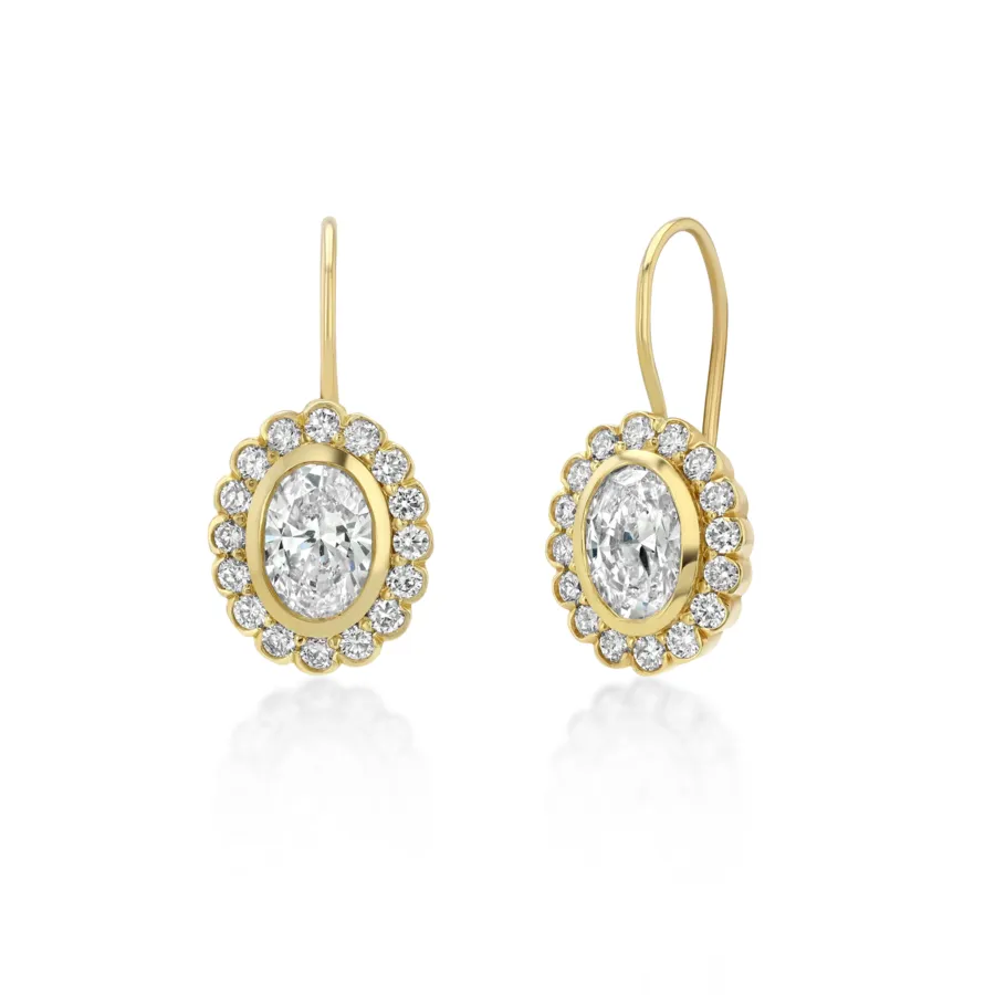 A pair of gold Heirloom drop earrings set with white stones.